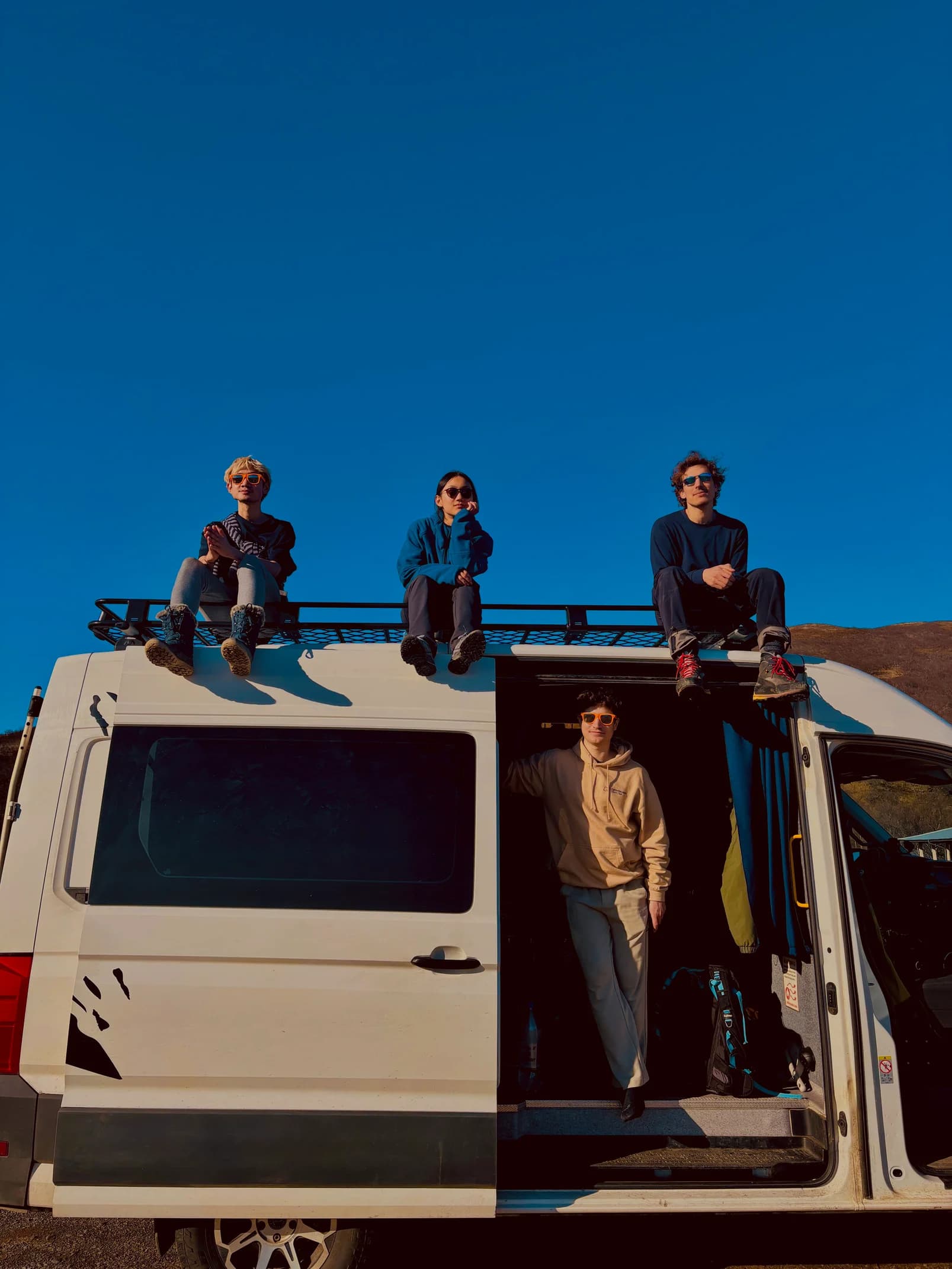 Friends standing on an Iceland campervan