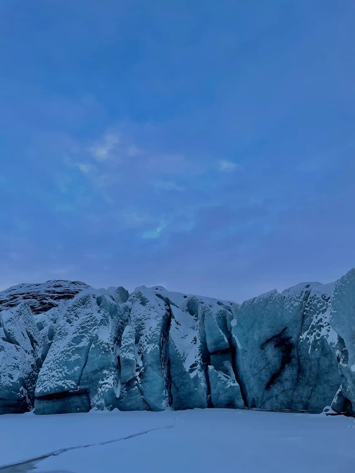 A blue Icelandic glacier beneath a winter sky