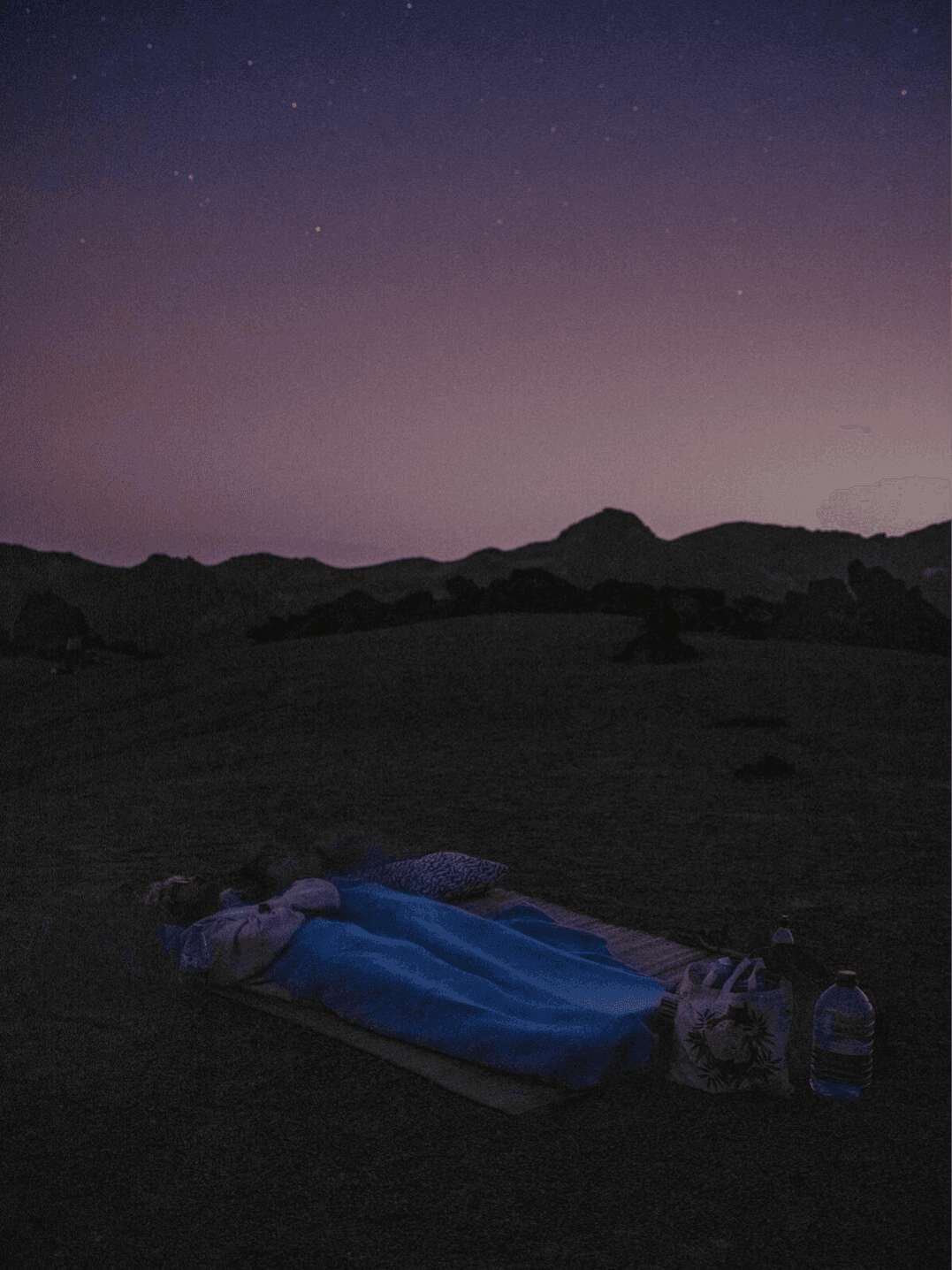 Travelers resting under the night sky in Tenerife
